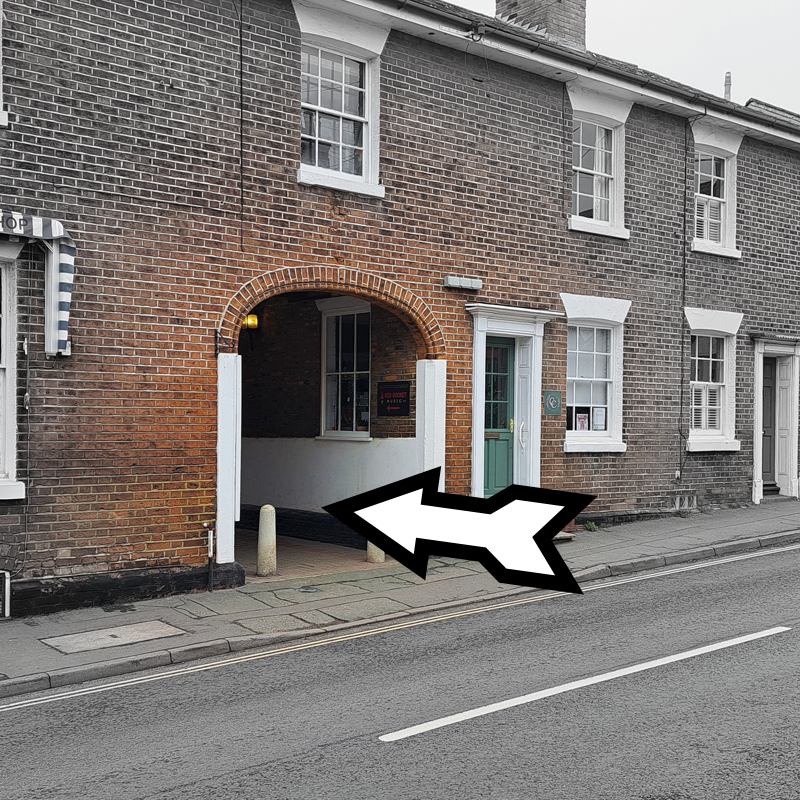 A view of the buildings opposite the Post Office. In the centre is the arch leading to Jolliffe's Yard